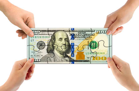 Hands and money puzzle isolated on white backgroundの写真素材