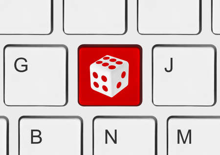 Computer keyboard with dice key - technology backgroundの写真素材