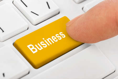 Computer notebook keyboard with Business key - technology background