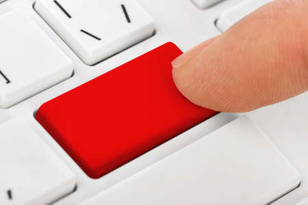Computer notebook keyboard with blank red key - technology background