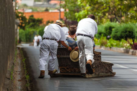 Toboggan riders on sledge in Monte - Funchal Madeira island - Portugalの写真素材