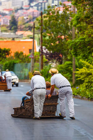 Toboggan riders on sledge in Monte - Funchal Madeira island - Portugalの写真素材