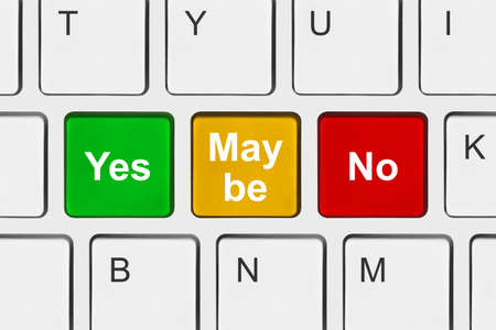 Computer keyboard with Yes No and Maybe keys - business concept