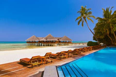 Pool and cafe on Maldives beach - nature vacation backgroundのeditorial素材