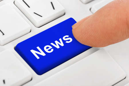 Computer notebook keyboard with News key - technology background