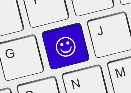 Computer keyboard with smile key - business conceptの写真素材