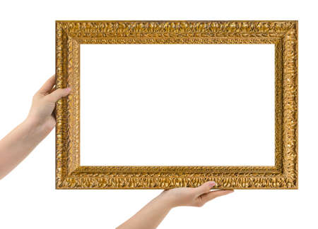 Wooden picture frame in hands isolated on white backgroundの写真素材