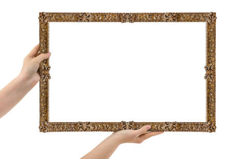 Wooden picture frame in hands isolated on white backgroundの写真素材