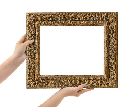 Wooden picture frame in hands isolated on white backgroundの写真素材