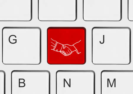 Computer keyboard with handshake button - technology background