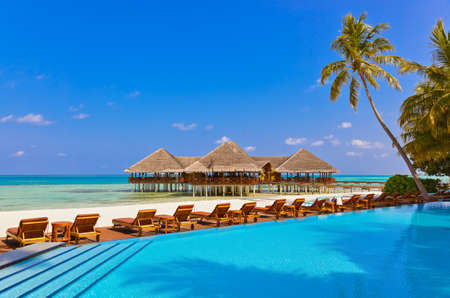 Pool and cafe on Maldives beach - nature vacation backgroundのeditorial素材