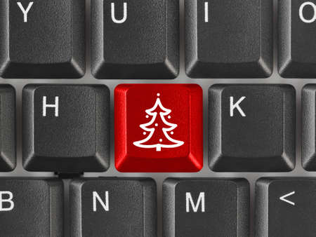 Computer keyboard with Christmas tree key - holiday conceptの写真素材