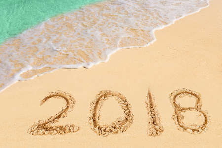 Numbers 2018 on beach - concept holiday background