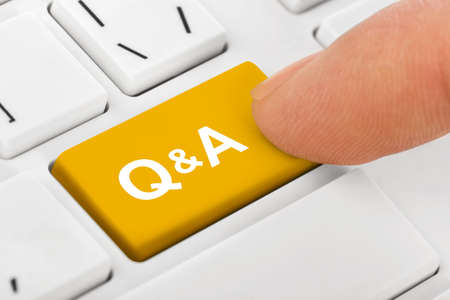 Computer notebook keyboard with Questions and Answers key - technology backgroundの写真素材