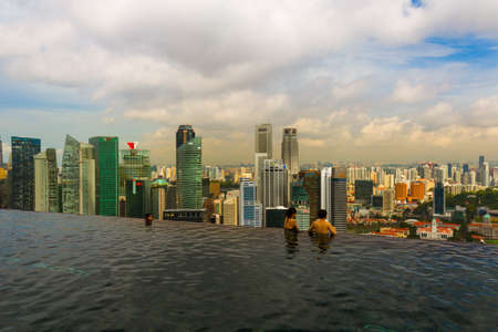 SINGAPORE - APRIL 15: Pool on roof and Singapore city skyline on April 15, 2016 in Singapore.のeditorial素材