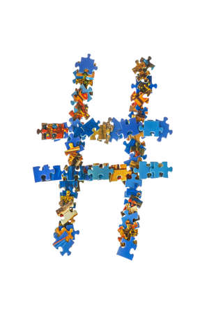 Symbol # made of puzzle pieces isolated on white backgroundの写真素材