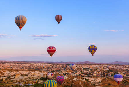 Hot air balloon flying over rock landscape at Cappadocia Turkeyの写真素材