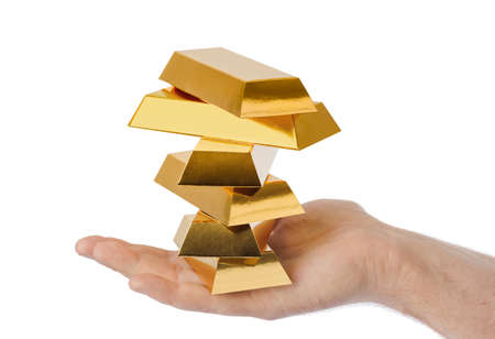 Hand with gold bars isolated on white backgroundの写真素材