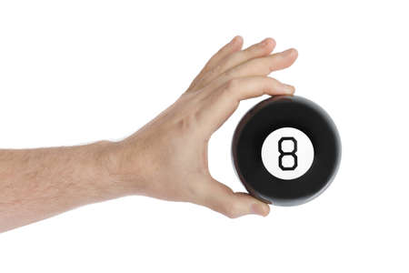 Hand with magic billiard ball number eight isolated on white backgroundの写真素材