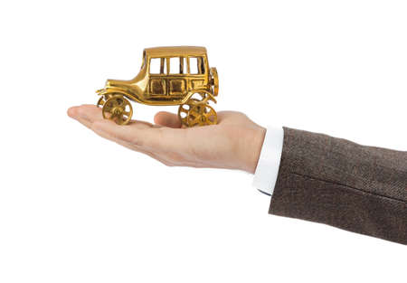 Hand and toy vintage car isolated on white background
