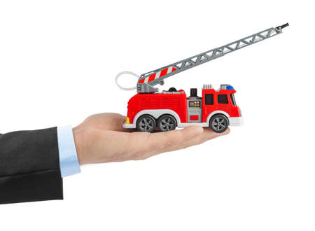 Hand with fire truck isolated on white background