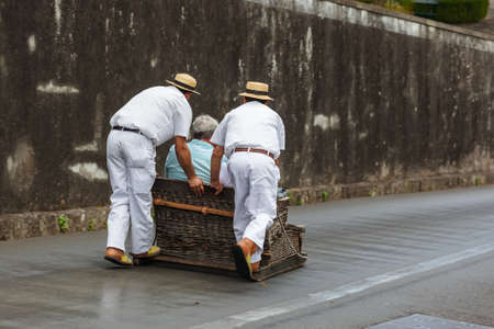 Toboggan riders on sledge in Monte - Funchal Madeira island - Portugal