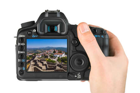 Hand with camera and Fortress in village Marvao - Portugal (my photo) isolated on white background