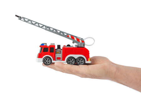 Hand with fire truck isolated on white background