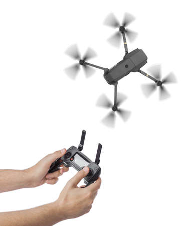 Drone and radio remote control in hands - isolated on white background