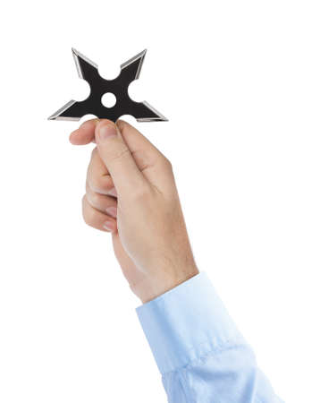 Hand is throwing ninja shuriken isolated on white backgroundの写真素材