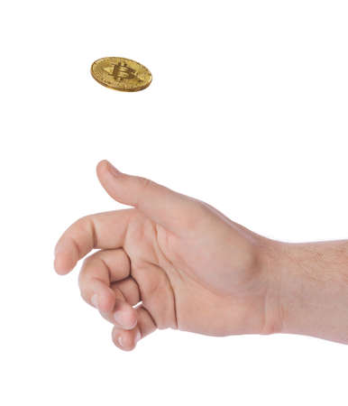 Hand tossing a bitcoin isolated on white backgroundの写真素材
