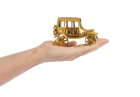 Hand and toy vintage car isolated on white backgroundの写真素材