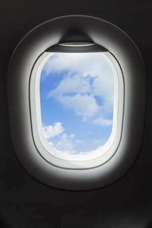 Sky in airplane window - travel backgroundの写真素材