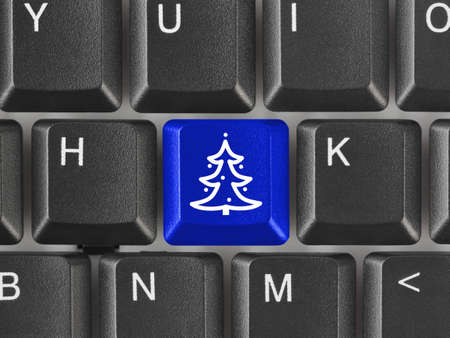 Computer keyboard with Christmas tree key - holiday conceptの写真素材