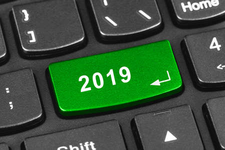 Computer notebook keyboard with 2019 key - holiday technology concept