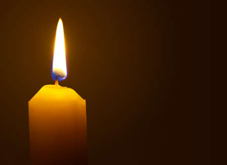 Macro of burning candle isolated on black backgroundの写真素材