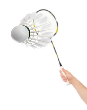 Hand with badminton racket and feather shuttlecock isolated on white backgroundの写真素材