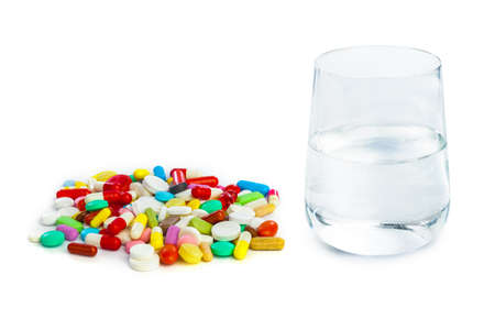 Heap of pills and water isolated on white background