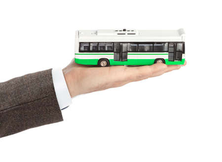 Hand with toy bus isolated on white backgroundの写真素材