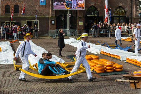 Alkmaar, Netherlands - April 28, 2017: Cheese carriers at traditional cheese market.のeditorial素材
