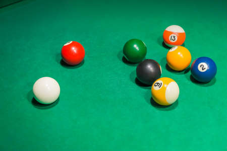 Billiard balls on pool green table - sport background