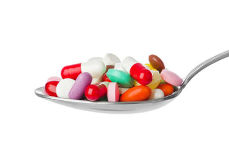 Spoon with pills isolated on white backgroundの写真素材