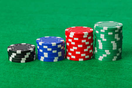 Casino chips on green table - gambling backgroundの写真素材