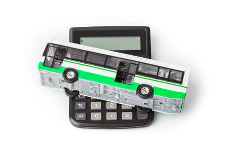 Calculator and toy bus isolated on white background