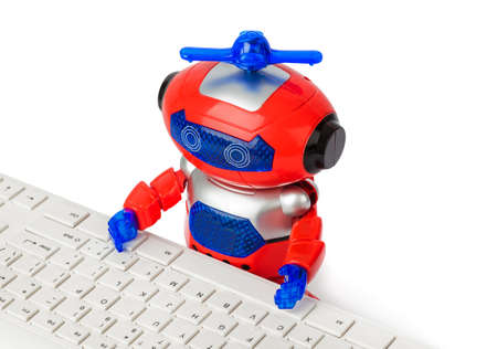 Toy robot and computer isolated on white background