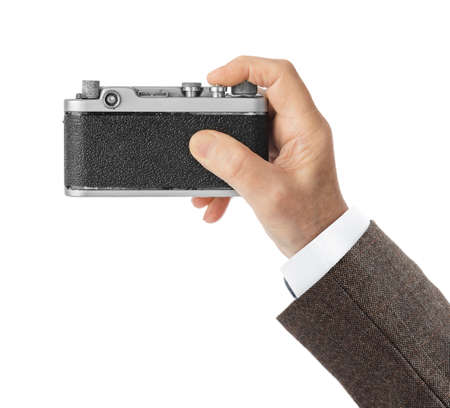 Vintage photo camera in hand isolated on white background