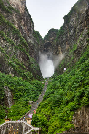Zhangjiajie, China - May 25, 2018: Tourists on pathway near Tianmen cave in Tianmenshan nature park.のeditorial素材