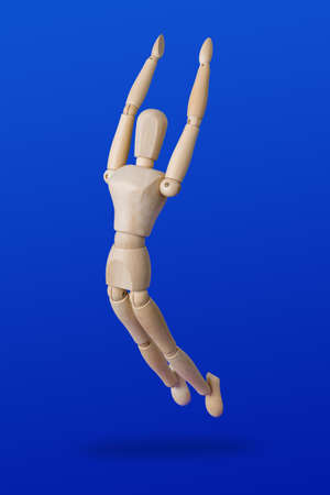 Sports wooden toy figure on blue backgroundの写真素材