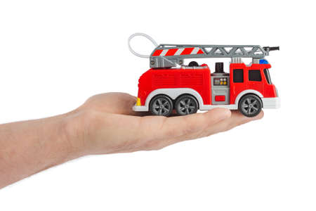 Hand with fire truck isolated on white background