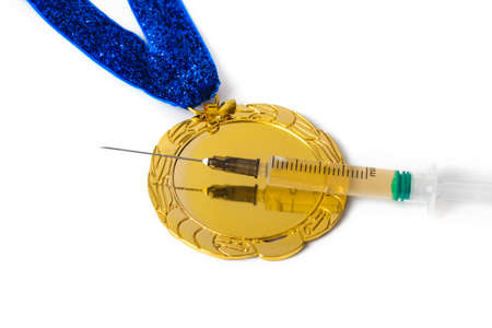 Gold medal and syringe isolated on white backgroundの写真素材
